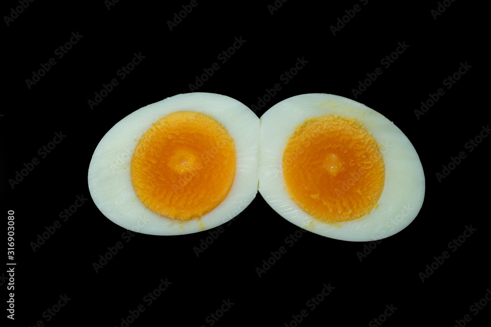 Boiled sliced chicken eggs isolated on Black background. No people. Boiled sliced chicken eggs isolated on Black background. No people.