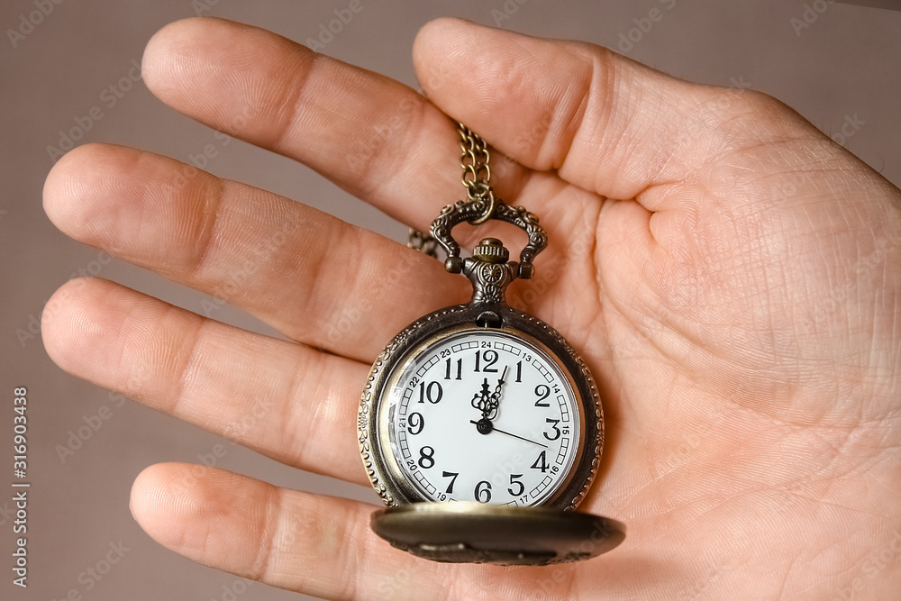a pocket watch in the hands of a man a pocket watch in the hands of a man