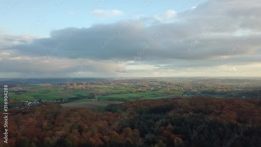 Panning over tree top with beautiful sky view with sun shining through clouds, Odenwald Germany. Panning over tree top with beautiful sky view with sun shining through clouds, Odenwald Germany.