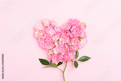Pink roses on pink background  heart shape