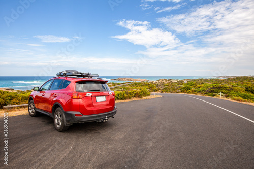 Red car parked in scenic spot along ocean drive in South Australia