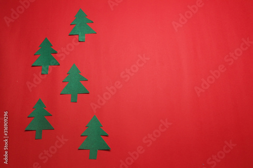 Handmade simple cutting paper craft Christmas tree on red paper ,minimalism concept