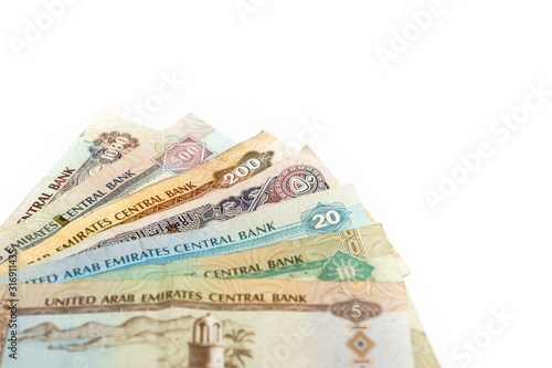 United Arab Emirates cash notes and coins isolated on white background. selective focus. high key photo