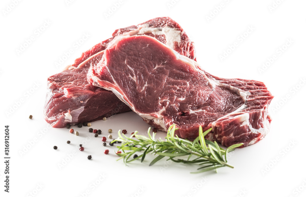 Beef Rib Eye steak with pepper and rosemary isolated on white background