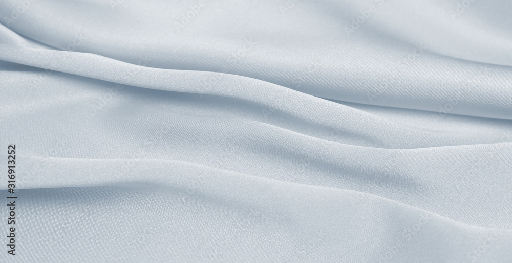 Fototapeta premium Draped satin blue fabric for festive backgrounds
