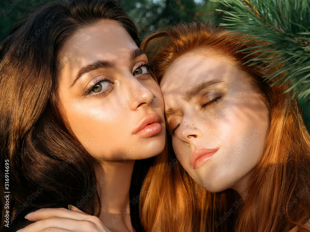 Beautiful gay couple sharing time together and having fun outdoor. Women friendship. Girls in boho fashion clothes. Happy girlfriends having tender moments. LGBT and relationship concept Beautiful gay couple sharing time together and having fun outdoor. Women friendship. Girls in boho fashion clothes. Happy girlfriends having tender moments. LGBT and relationship concept