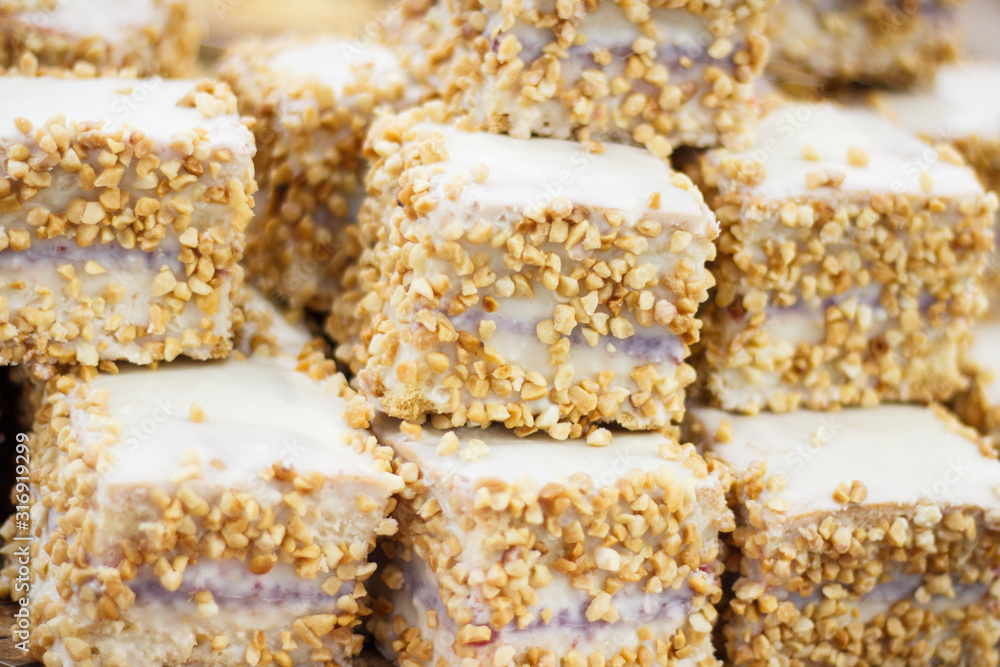 Pieces of fresh baked cake with icing and nuts Pieces of fresh baked cake with icing and nuts