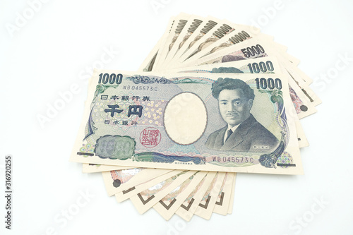 Close up of variety of Japanese yen currency banknotes lay flat and isolate on white background with copy space. photo