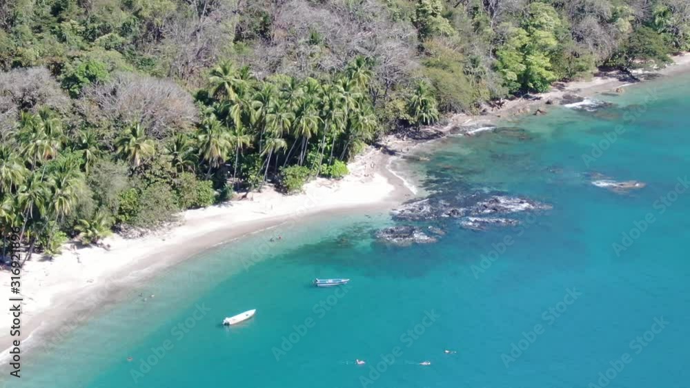 Boats at a tropical beach with white sand in the ocean Boats at a tropical beach with white sand in the ocean