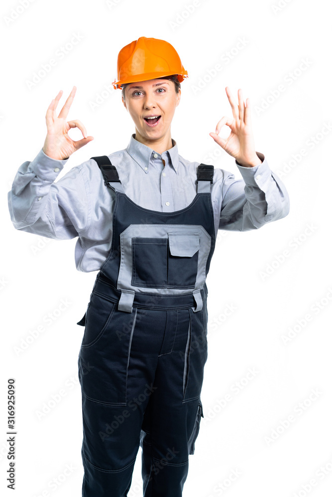 European engineer woman shows OK with both hands. Isolated European engineer woman shows OK with both hands. Isolated