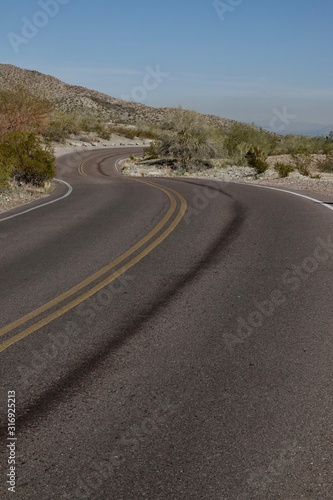 A paved road curves through the desert