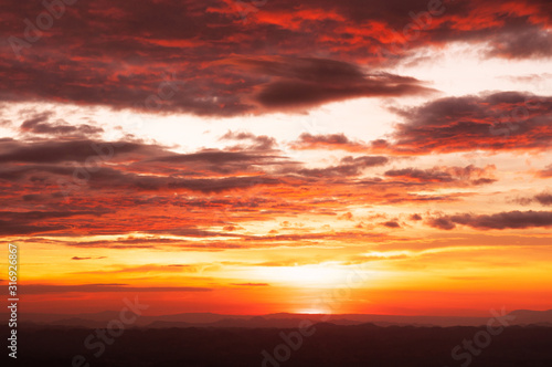 Beautiful red vibrant burning sunset sky with clouds © PixHound