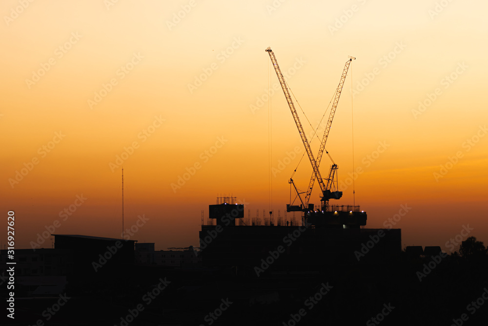 silhouette  of the factory,industrial with beautiful sunset in the evening for background.