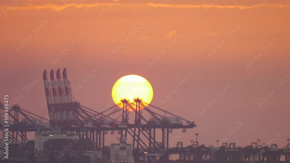Sunset and cranes at cargo wharf Sunset and cranes at cargo wharf