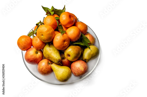 Apples  pears and tangerines in a plate isolated on a white background.