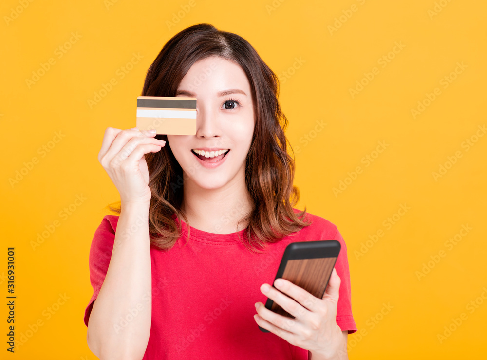 happy young woman holding smart phone and credit card. happy young woman holding smart phone and credit card.