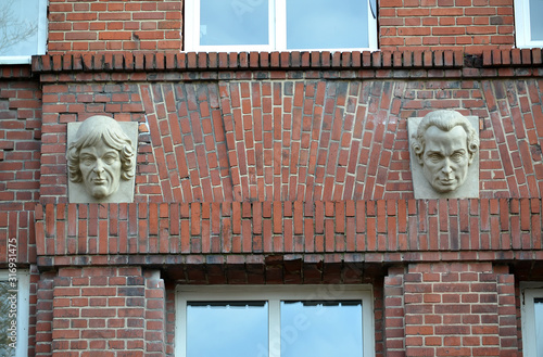 KALININGRAD, RUSSIA.  Sculpture portraits of Nikolai Copernicus and Immanuel Kant on the brick facade of the building of gymnasium № 1 photo