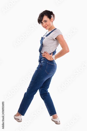 young beautiful girl in denim overalls on a white isolated background 