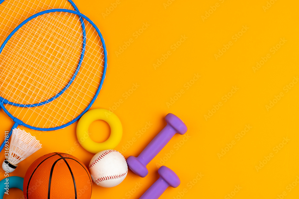 Assortment of sport equipment on yellow background, top view - obrazy, fototapety, plakaty 