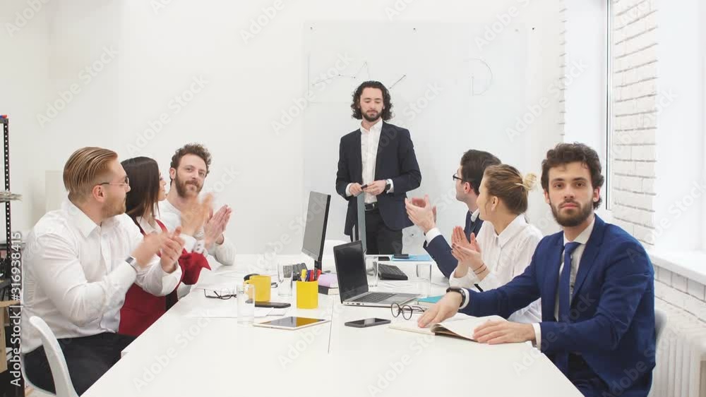 Young caucasian brunette boss applause with workers in business office, congratulate and celebrate, wearing formal clothes, sitting at table Young caucasian brunette boss applause with workers in business office, congratulate and celebrate, wearing formal clothes, sitting at table