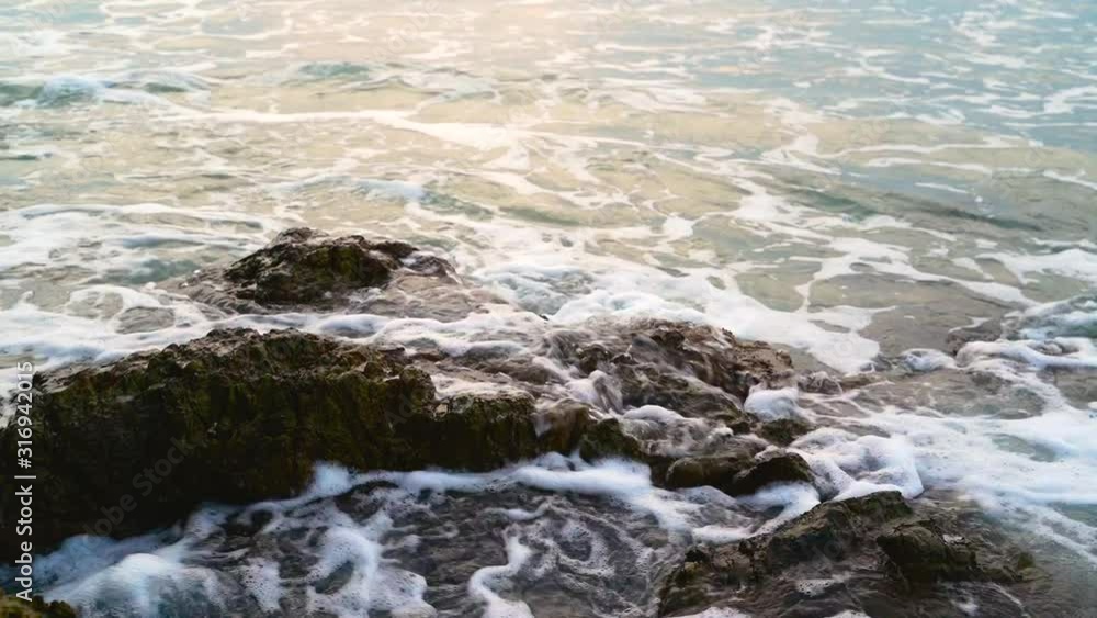 Sea waves hit the rocks during sunrise time. Sea waves hit the rocks during sunrise time.