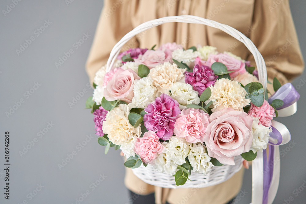 Flowers delivery. Flower arrangement in Wicker basket. Beautiful bouquet of mixed flowers in woman hand. Floral shop concept . Handsome fresh bouquet. Flowers delivery. Flower arrangement in Wicker basket. Beautiful bouquet of mixed flowers in woman hand. Floral shop concept . Handsome fresh bouquet.
