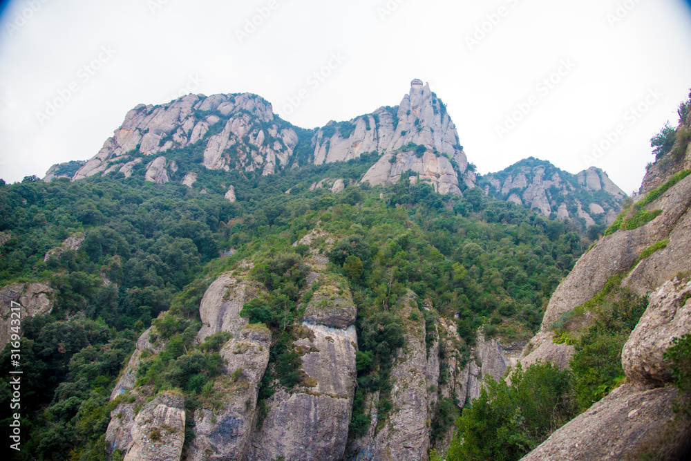 BARCELONA, SPAIN - December 26, 2018: The mountains of Montserrat in Barcelona, Spain. Montserrat  is a Spanish shaped mountain which influenced Antoni Gaudi to make his art works.