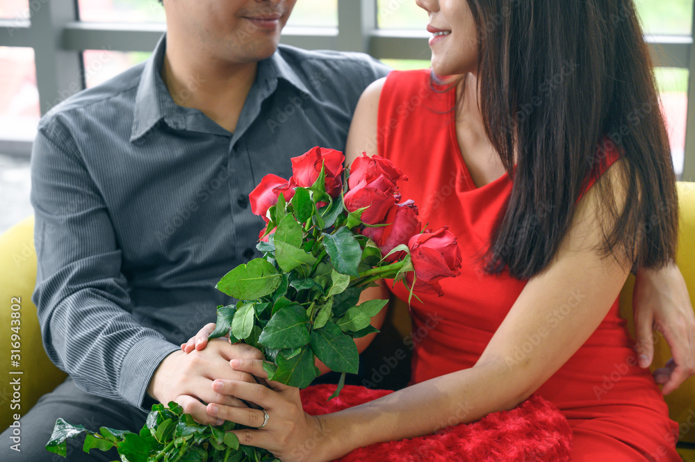 Man giving flowers to his lover on Valentine Day at home. Man giving flowers to his lover on Valentine Day at home.