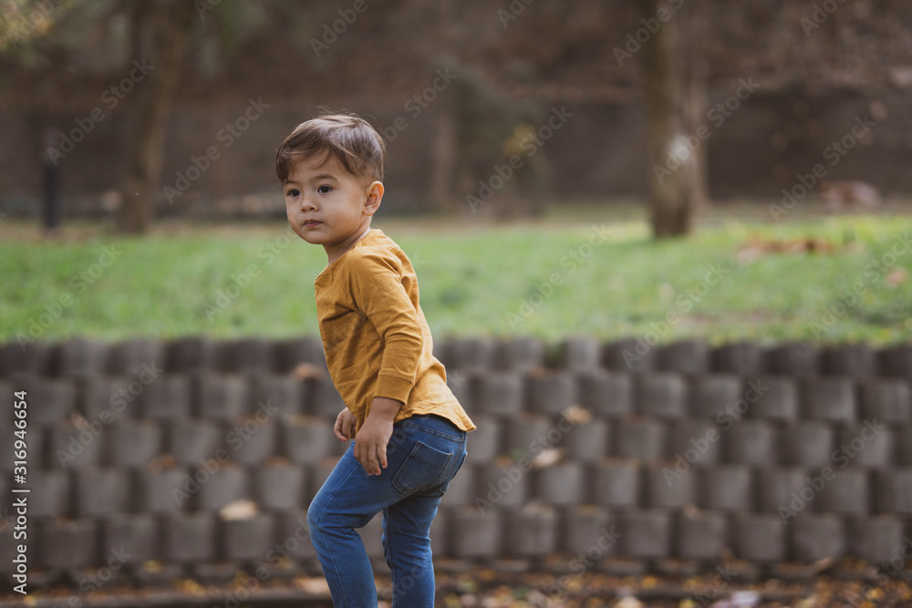 happy young boy playing outdoors in the park happy young boy playing outdoors in the park