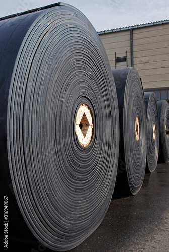  New industrial conveyor belts packed in rolls. 