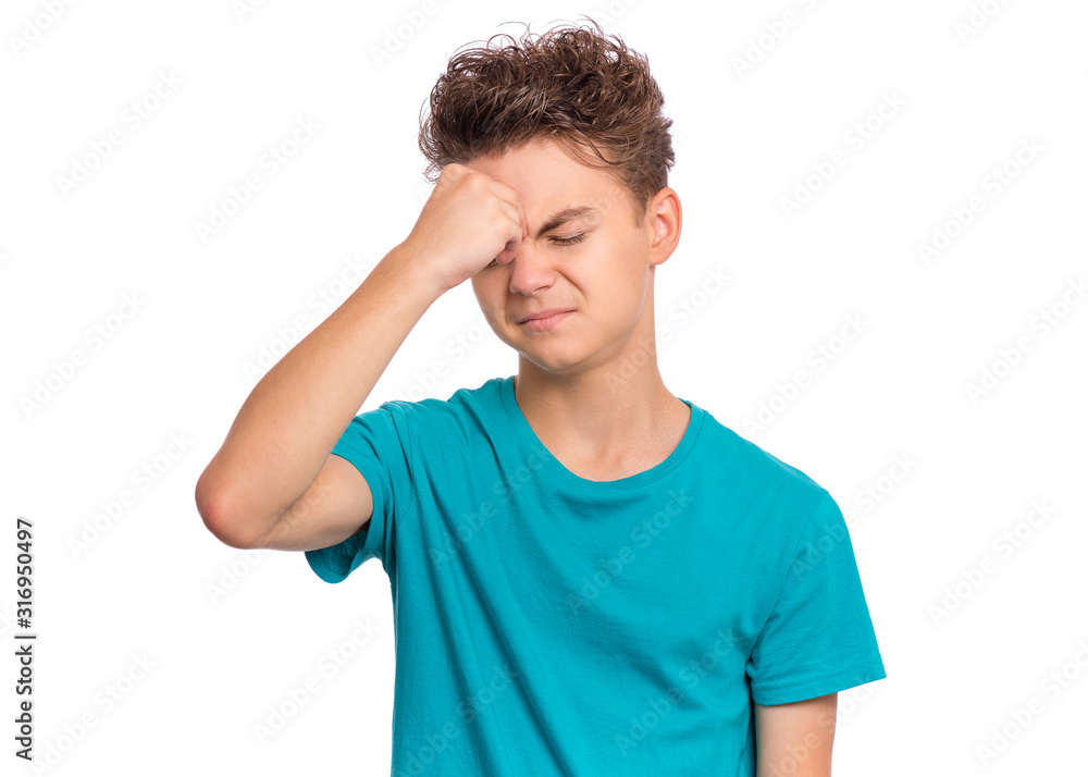 Portrait of teen boy touching his head suffering headache, tired and sad. Unhappy beautiful caucasian young teenager suffering from headache, isolated on white background. Portrait of teen boy touching his head suffering headache, tired and sad. Unhappy beautiful caucasian young teenager suffering from headache, isolated on white background.