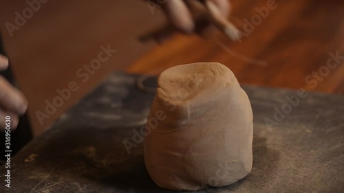 Wallpaper Mural A man kneads clay in a pottery workshop. Male hands closeup knead clay. Clay modeling workshop. Torontodigital.ca