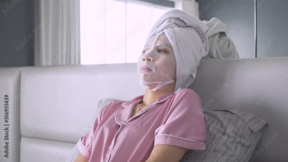 Woman wearing facial mask and sleeping on bed Woman wearing facial mask and sleeping on bed