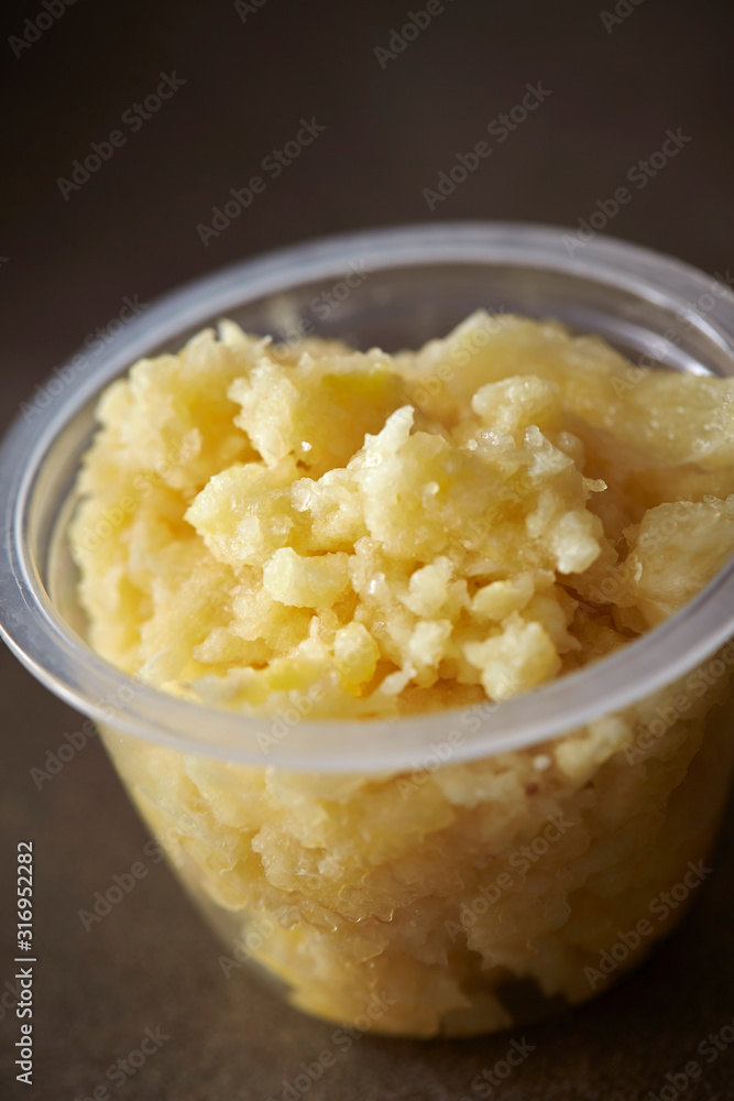Crushed garlic in plastic bowl Crushed garlic in plastic bowl