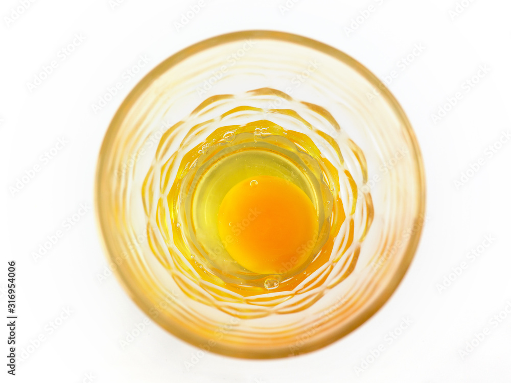 Raw eggs in a glass bowl on white background Raw eggs in a glass bowl on white background