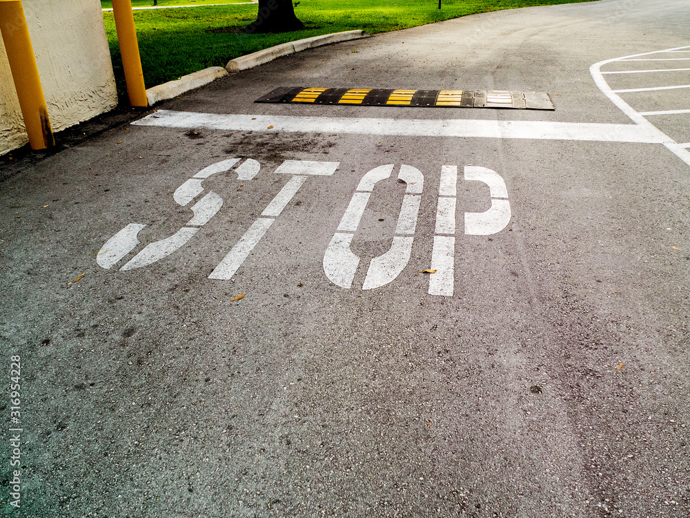 Fototapeta premium Stop Sign on Asphalt with a Speed Bump