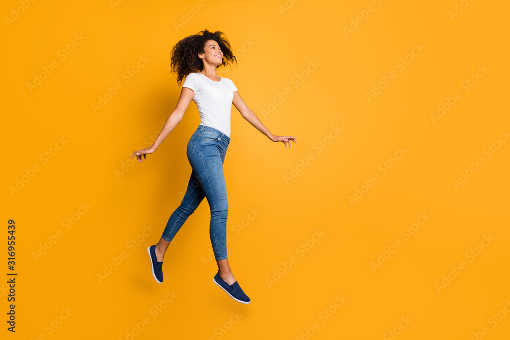 Full length body size side profile photo of cheerful cute nice positive pleased girl wearing jeans denim white t-shirt running jumping to goods discounted isolated over vivid color background Full length body size side profile photo of cheerful cute nice positive pleased girl wearing jeans denim white t-shirt running jumping to goods discounted isolated over vivid color background