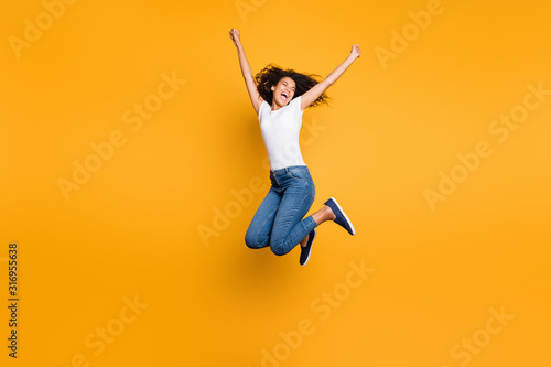 Full length body size view of her she nice attractive lovely cheerful cheery wavy-haired girl jumping having fun vacation holiday isolated over bright vivid shine vibrant yellow color background
