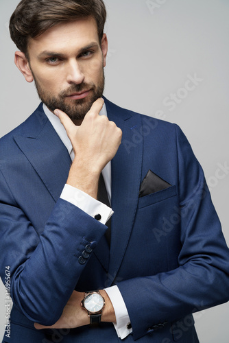 Studuo shot of thinking businessman wearing suit photo