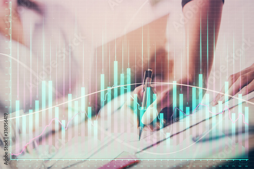 Wallpaper Mural A woman hands writing information about stock market in notepad. Forex chart holograms in front. Concept of research. Double exposure Torontodigital.ca