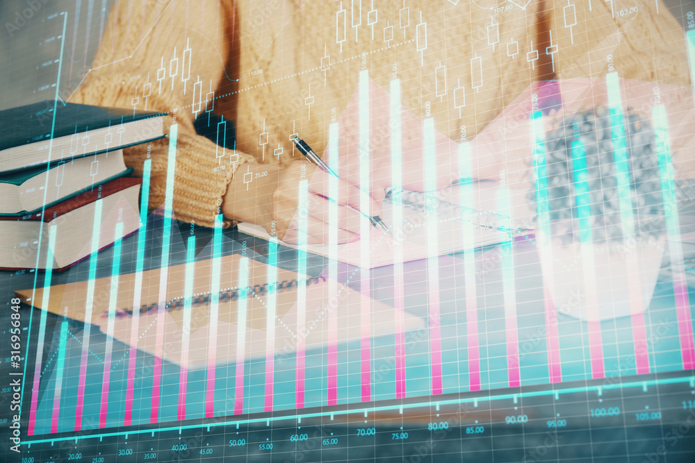 Forex graph on hand taking notes background. Concept of research. Double exposure