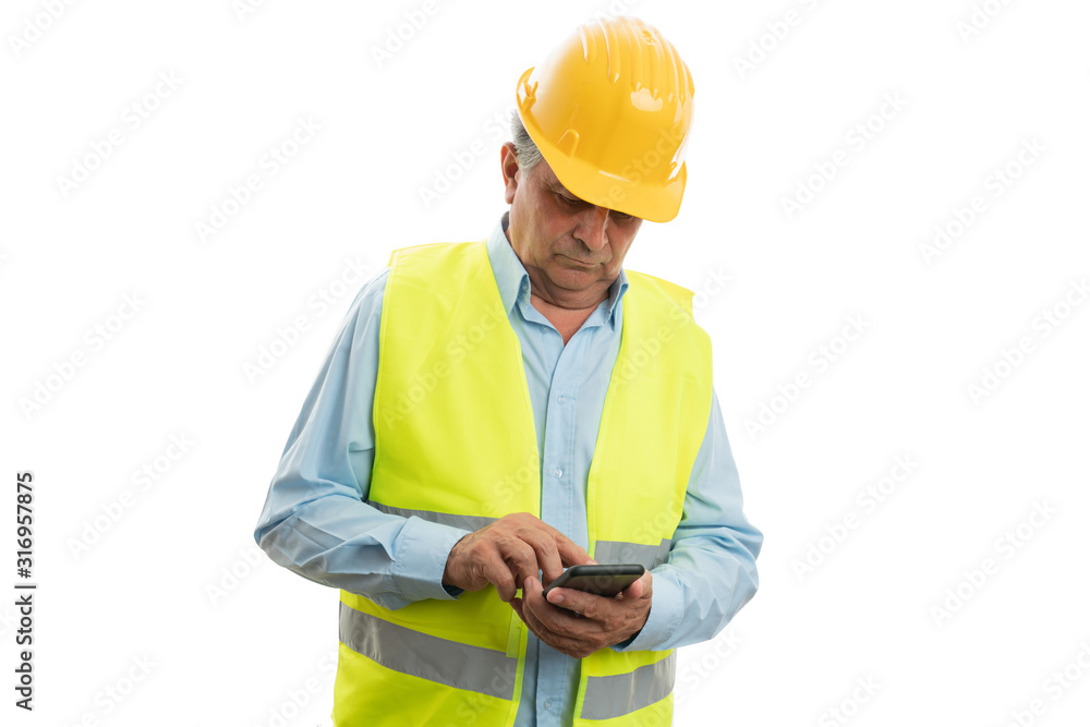 Builder looking at telephone Builder looking at telephone
