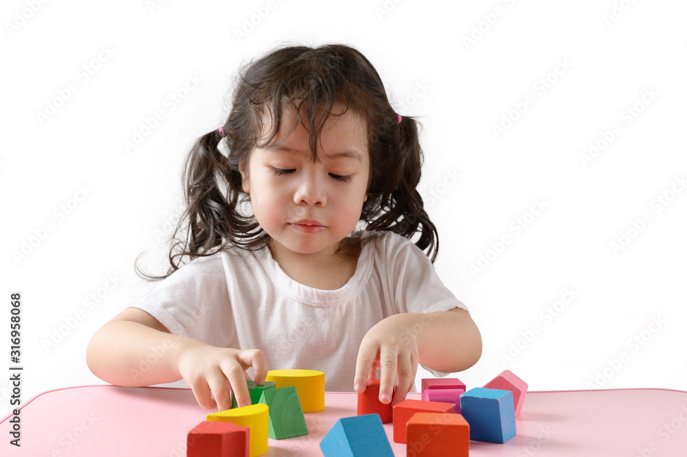Little curly asian girl enjoy playing toy at home. Education Concept. Little curly asian girl enjoy playing toy at home. Education Concept.