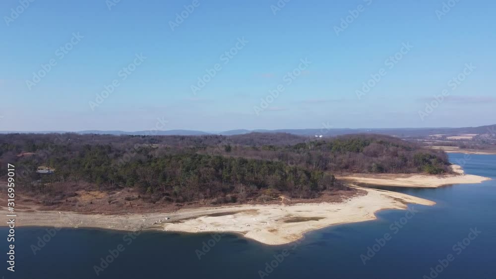 blue lake, winter day, camera moving to the right, leafless trees blue lake, winter day, camera moving to the right, leafless trees
