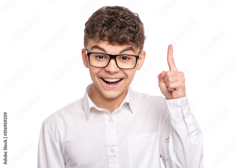 Handsome caucasian Teen Boy in white shirt with eyeglasses, isolated on white background. Teenager wearing glasses looking at camera. Happy child smiling and pointing finger up - new idea.