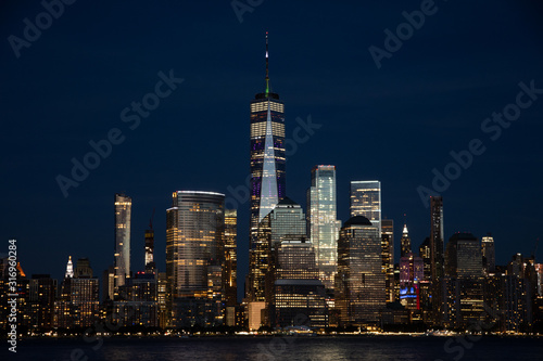 Lower Manhattan and One World Trade Center in New York City, USA as seen from New Jersey durin night