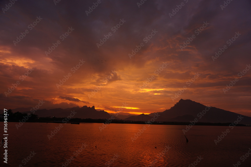 sunset and sunrise on the beach with a mountain backdrop sunset and sunrise on the beach with a mountain backdrop