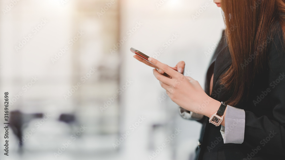 Cropped shot of professional businesswomen holding smartphone Cropped shot of professional businesswomen holding smartphone