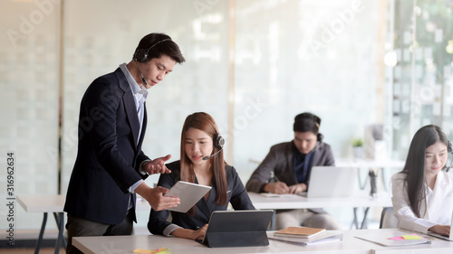 Close up view of female customer service talking on headset in call centre operation room