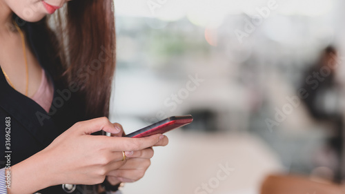 Close up view of professional businesswomen using on smartphone
